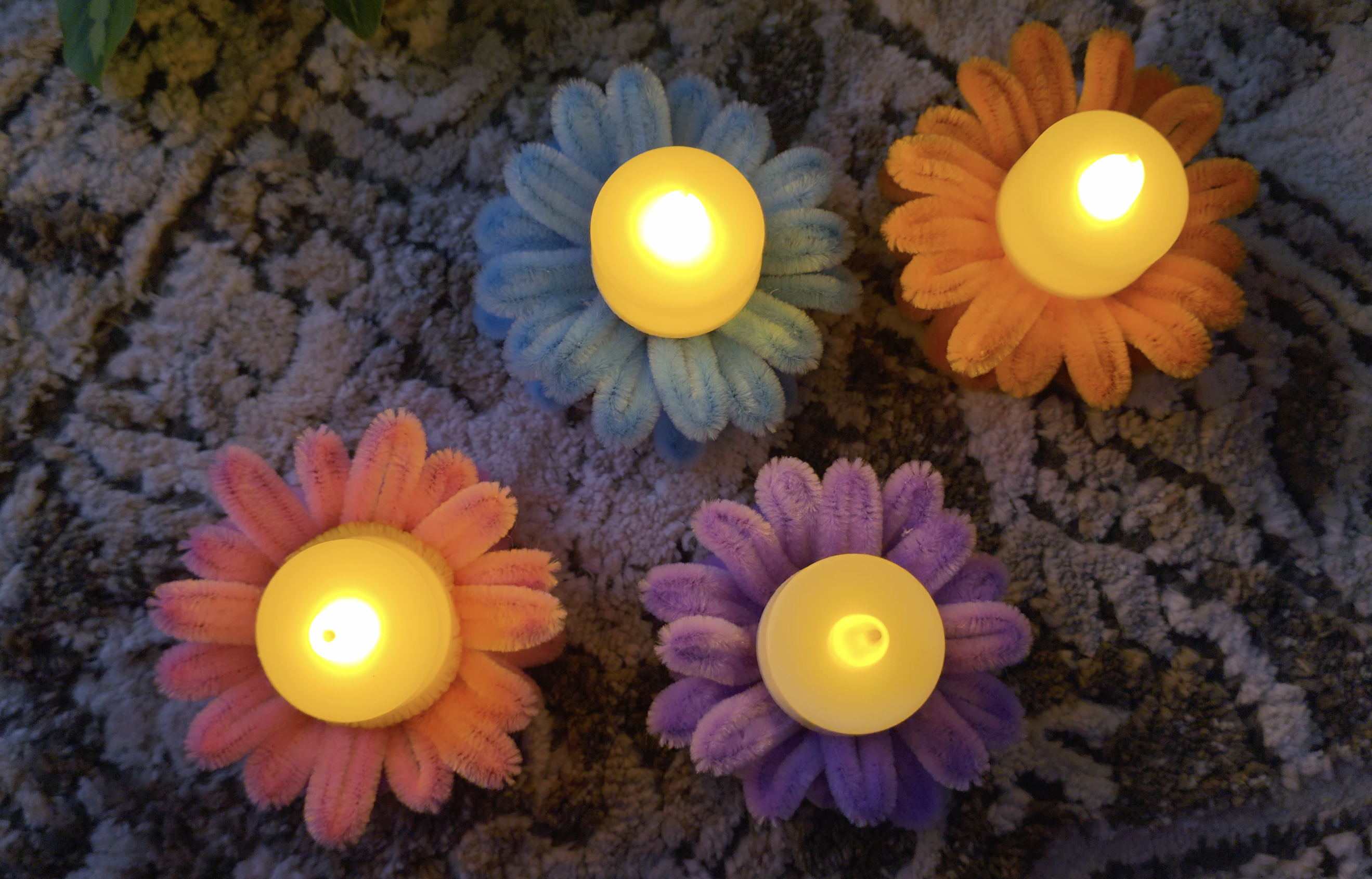 Bloom Daisy Lamp Holder — A cheerful handmade floral lamp holder decorated with soft pipe-cleaner daisies in playful pastel shades. Perfect for adding a colorful handmade touch to bedrooms, desks, shelves, or cozy corners.